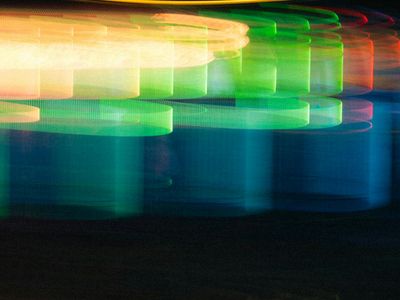 Abstract motion blur of a person exercising with cyan light